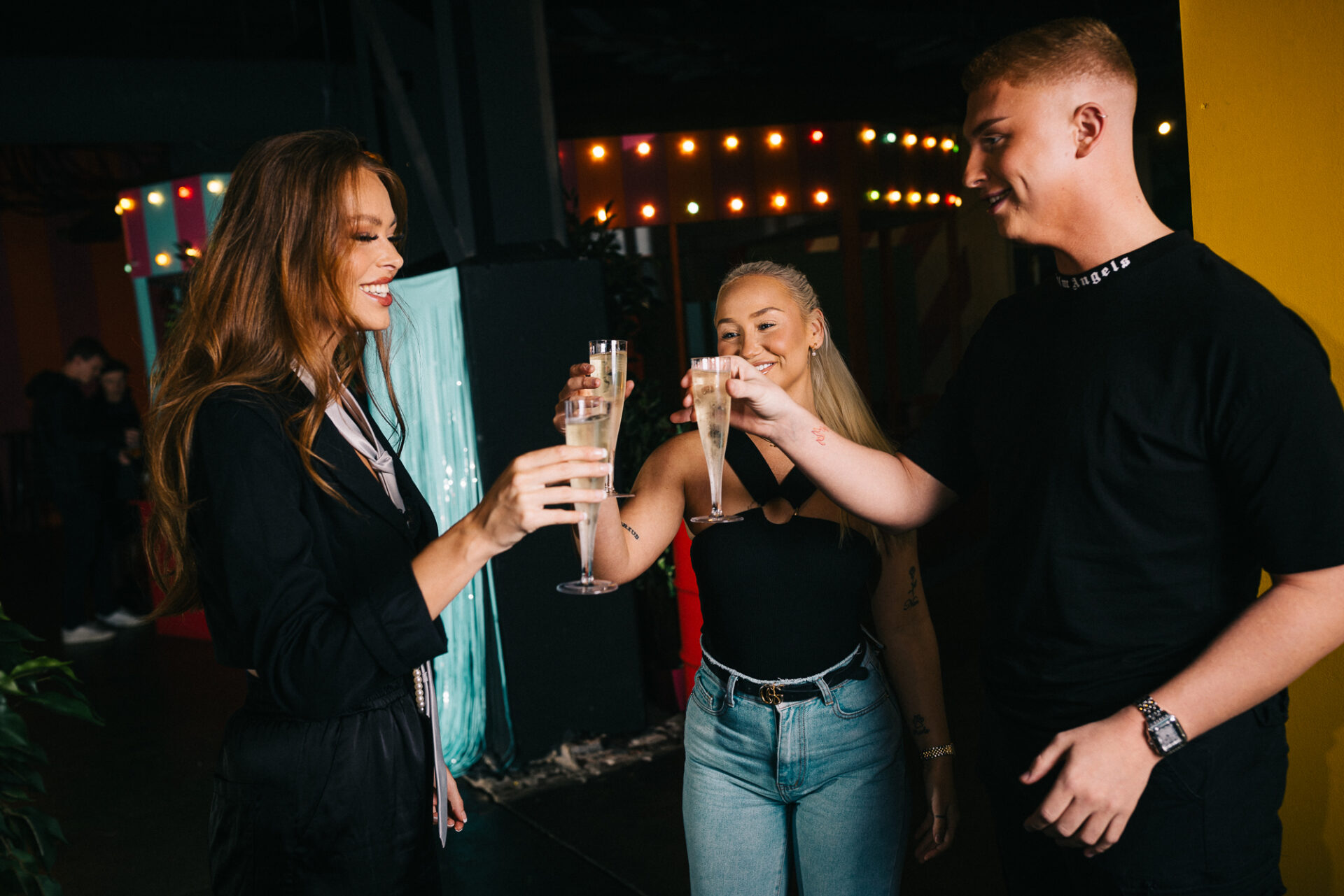 A group of colleagues cheers with prosecco glasses