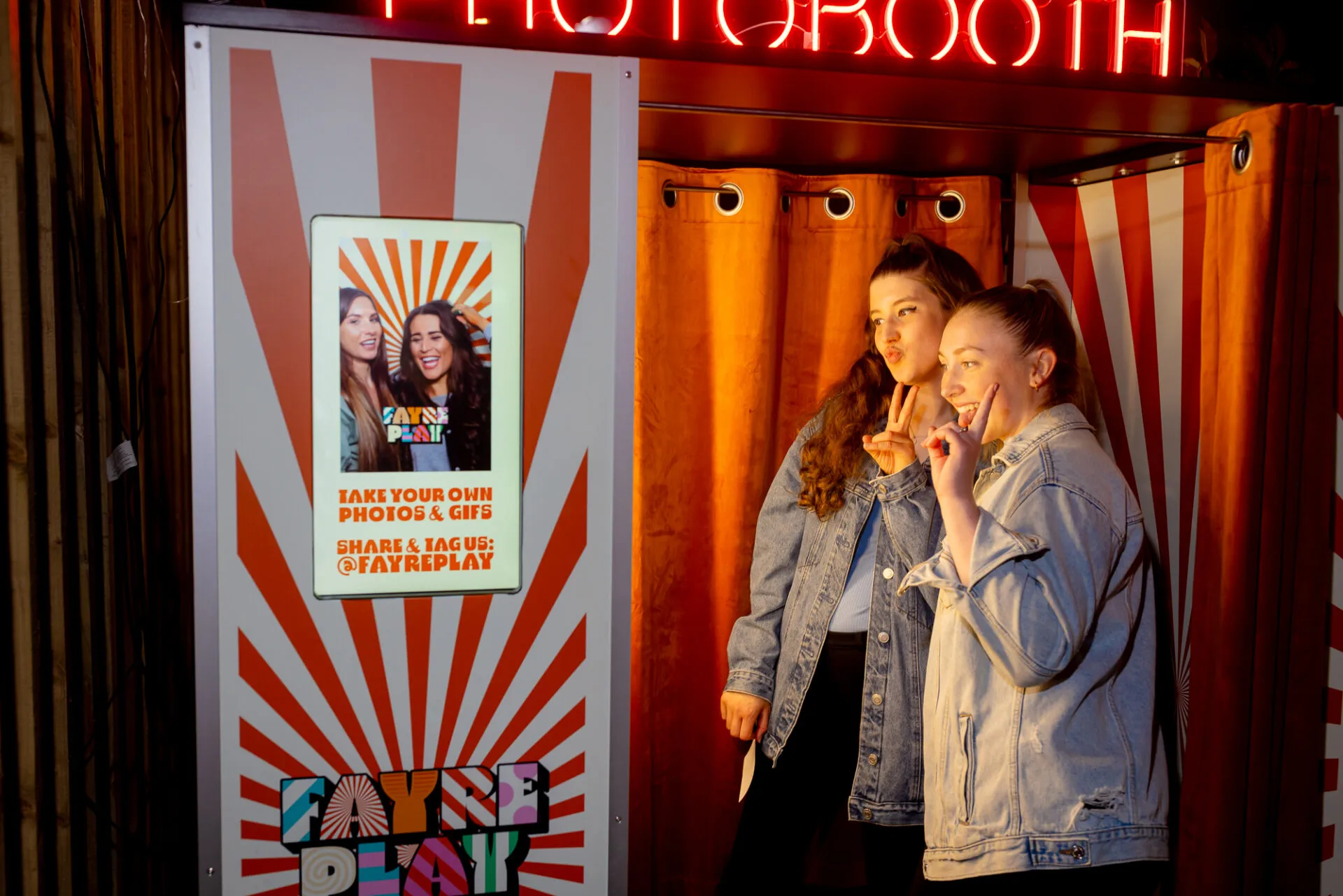 2 Girls Pose in a Photobooth
